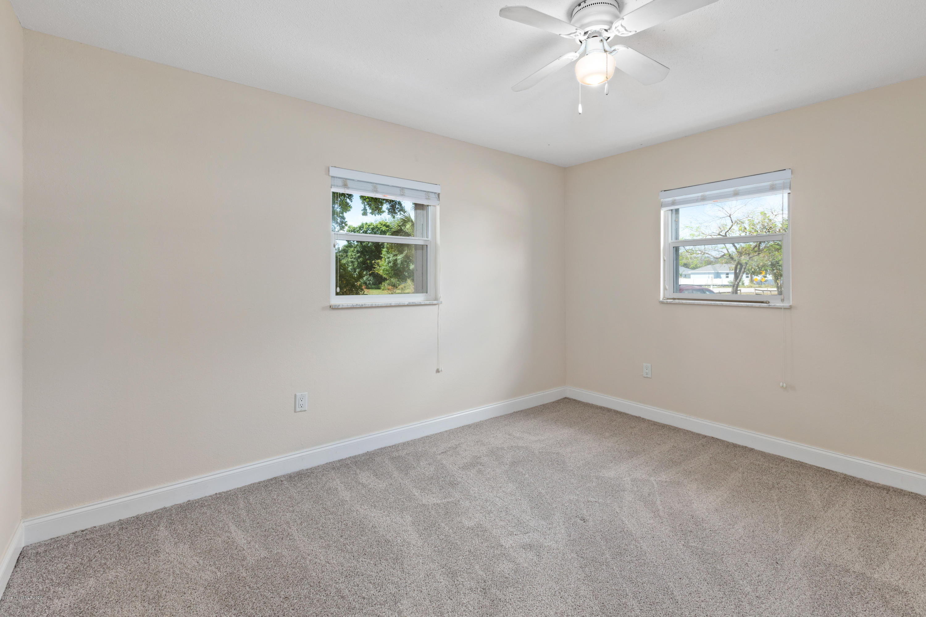 839 Knecht Road Northeast Palm Bay, FL 32905 - Photo 28 of 37 an empty room with windows and fan