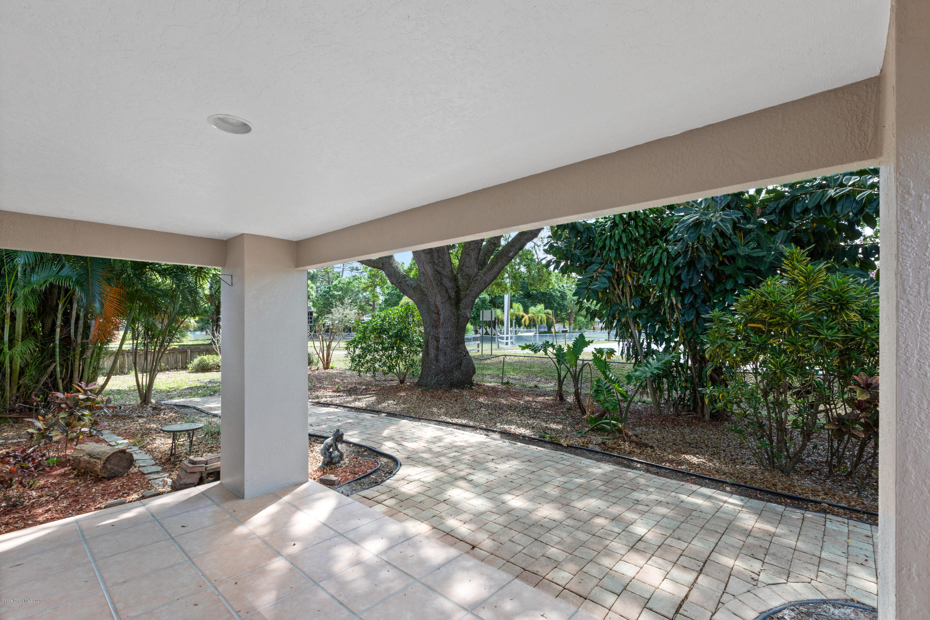 839 Knecht Road Northeast Palm Bay, FL 32905 - Photo 4 of 37 a view of a backyard with large trees and plants