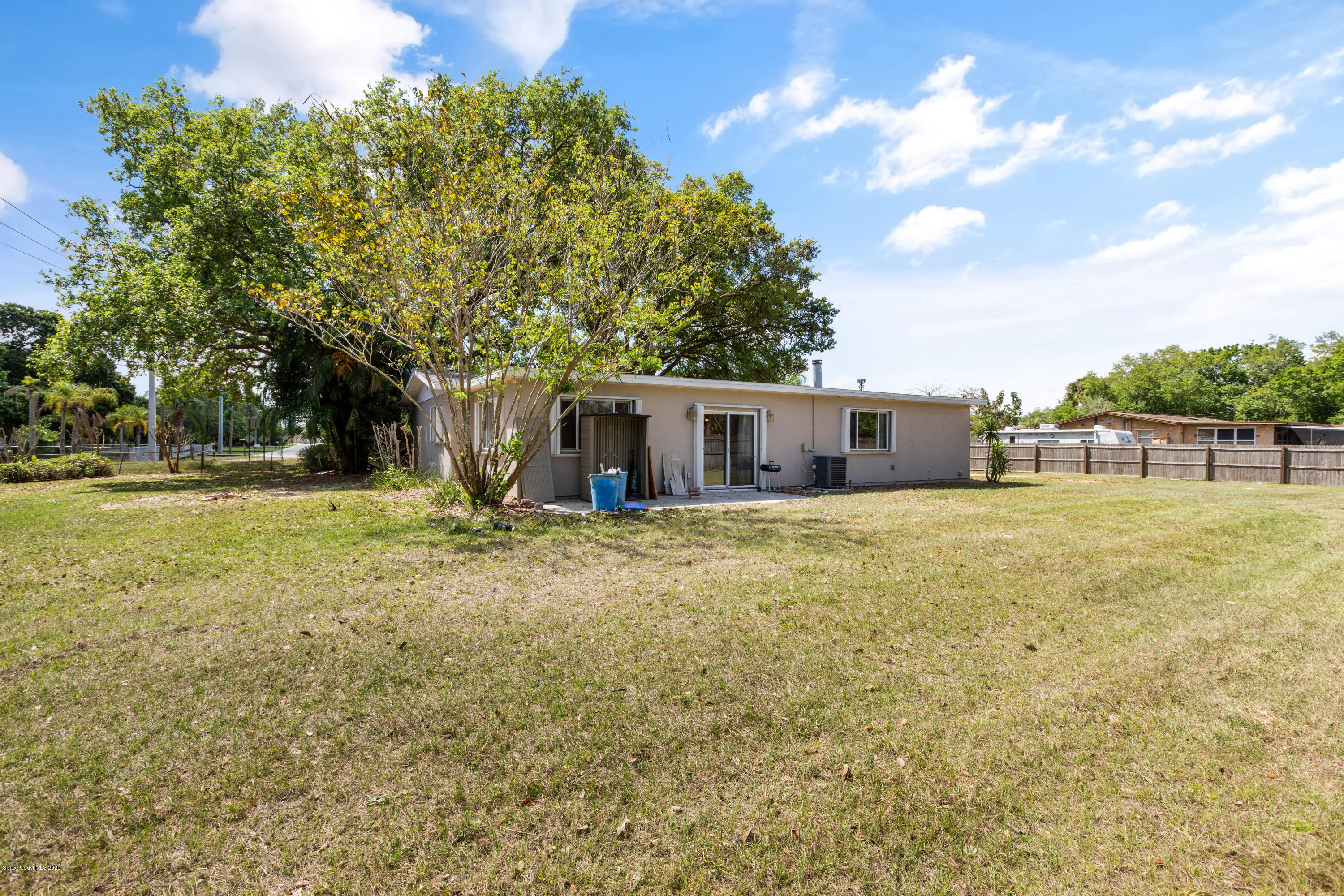 839 Knecht Road Northeast Palm Bay, FL 32905 - Photo 35 of 37 a front view of house with yard and trees