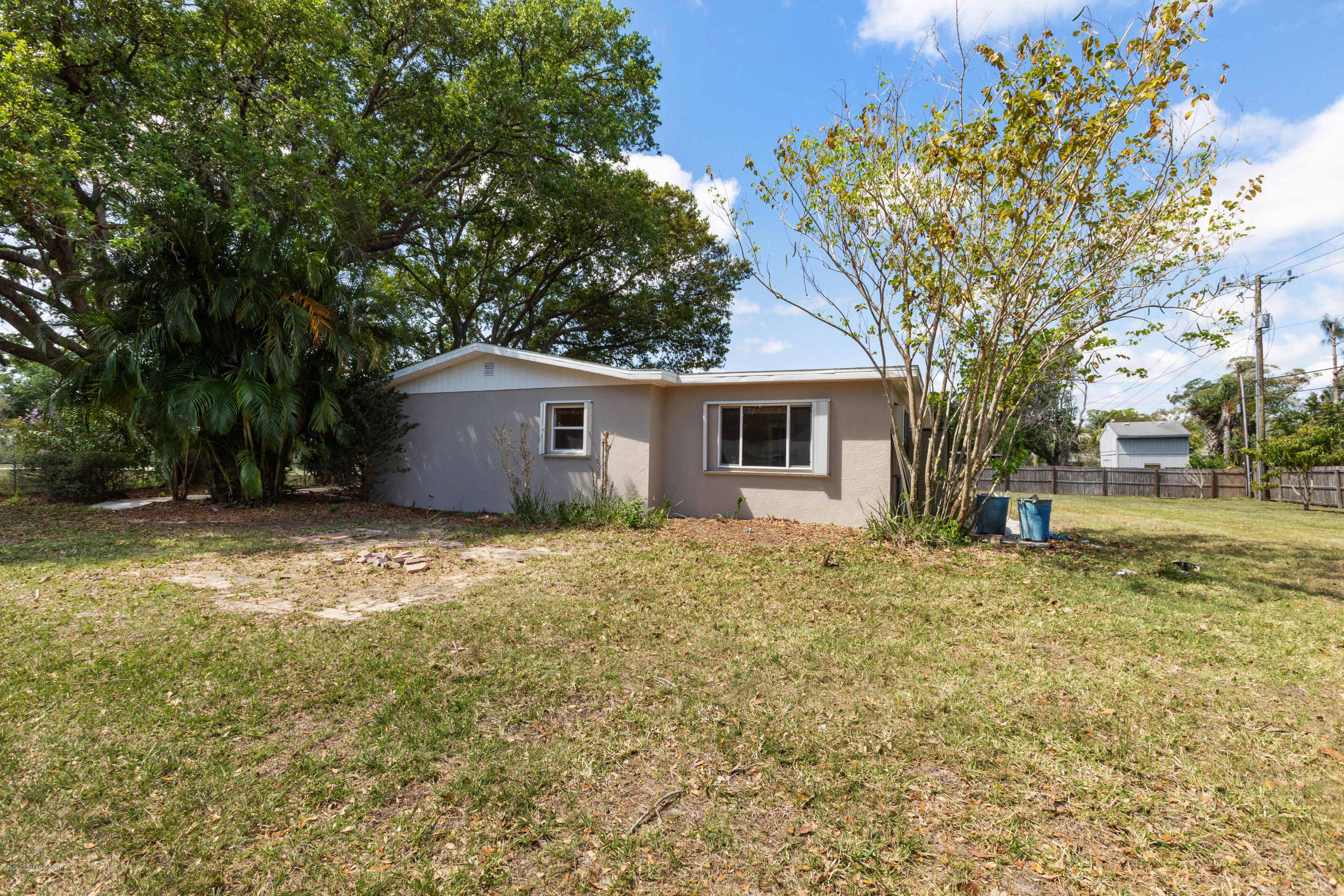 839 Knecht Road Northeast Palm Bay, FL 32905 - Photo 36 of 37 a house with trees in front of it