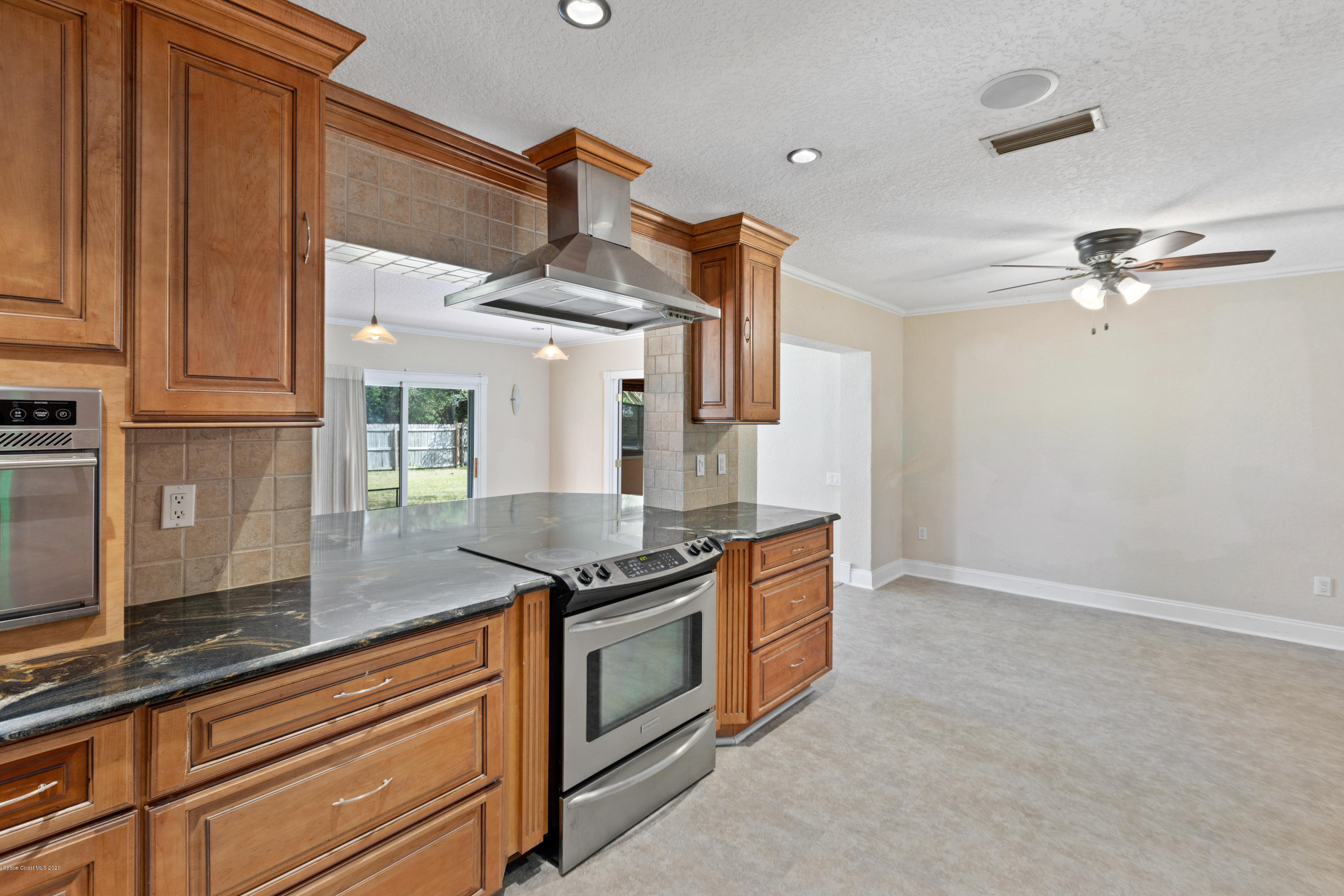 839 Knecht Road Northeast Palm Bay, FL 32905 - Photo 10 of 37 a kitchen with stainless steel appliances granite countertop a sink a stove and a refrigerator