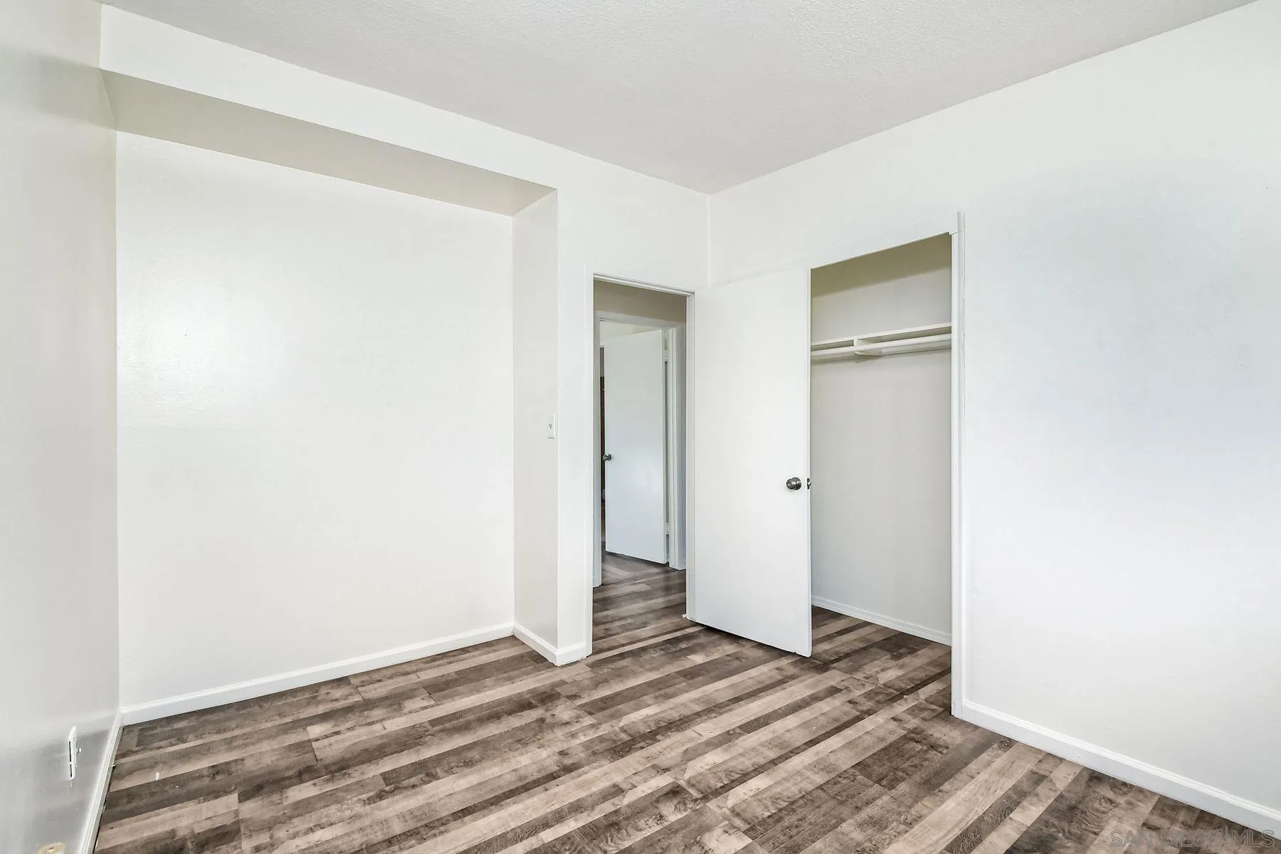1220 Bluegrass Road Vista, CA 92083 - Photo 17 of 25 a view of a room with wooden floor and hallway