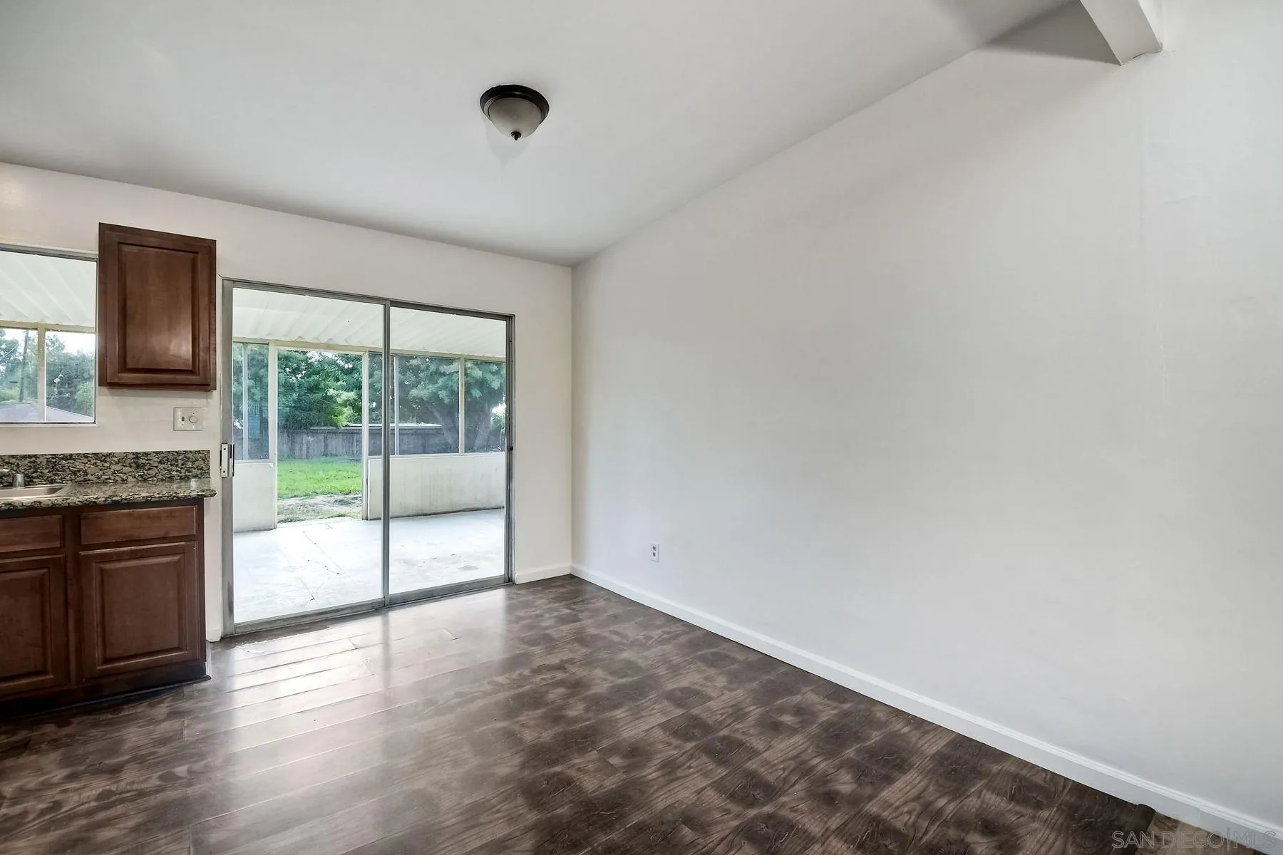 1220 Bluegrass Road Vista, CA 92083 - Photo 8 of 25 a view of empty room with wooden floor and fan