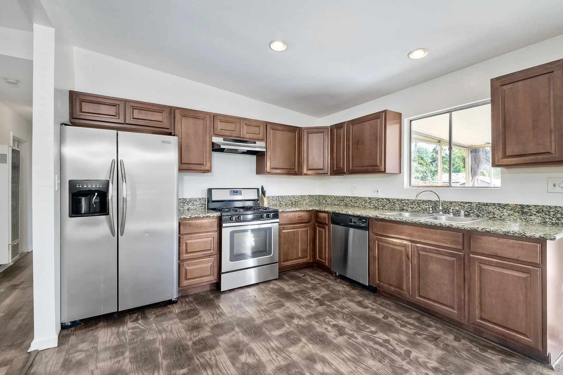 1220 Bluegrass Road Vista, CA 92083 - Photo 9 of 25 a kitchen with stainless steel appliances granite countertop a refrigerator sink and stove