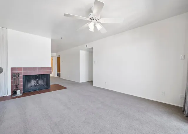 a view of an empty room with a fireplace