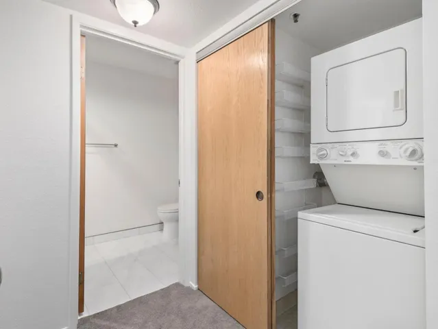 a view of bathroom with a toilet a sink and a mirror
