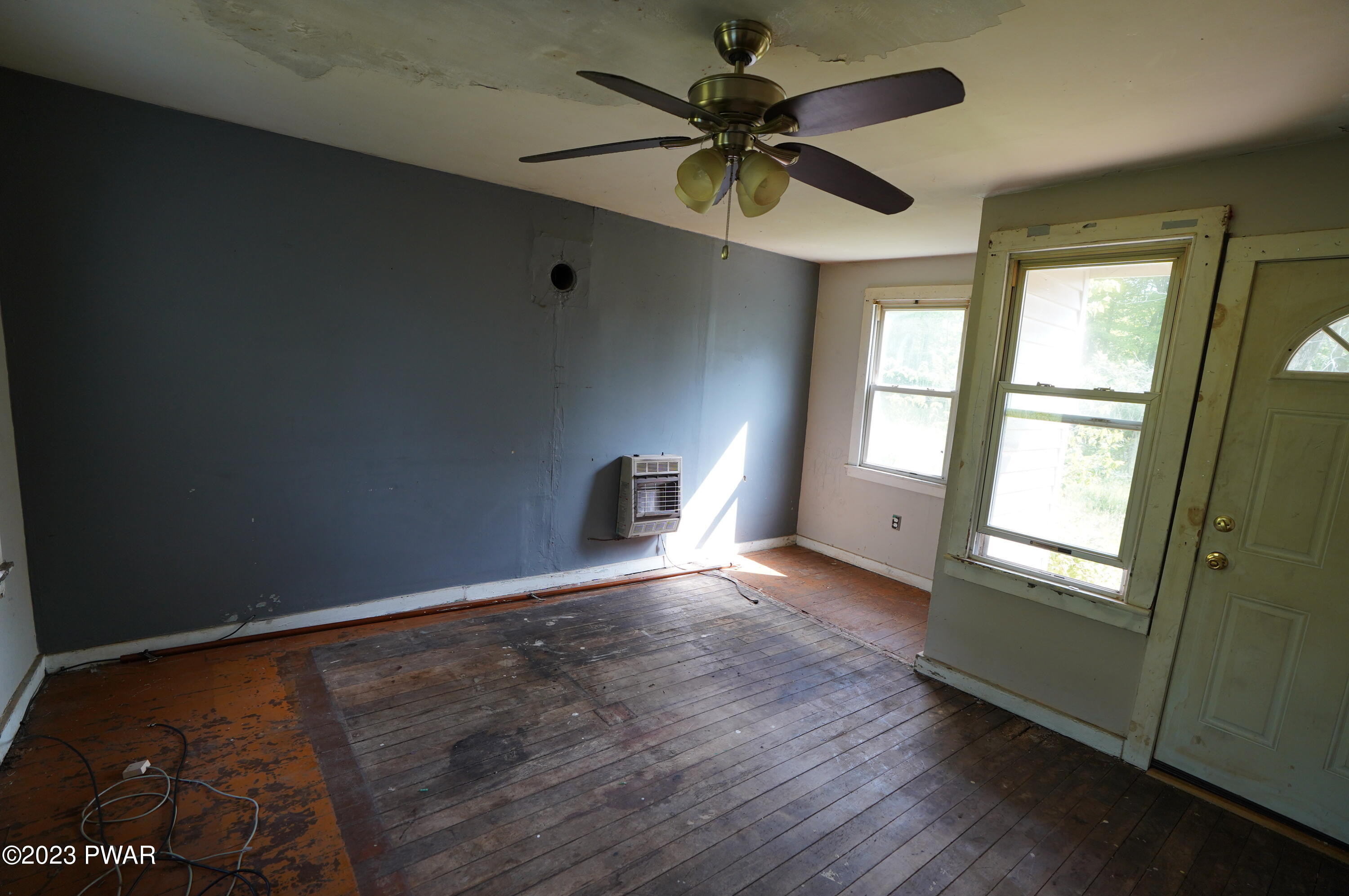 147 Daniels Road Lake Ariel, PA 18436 - Photo 8 of 25 an empty room with wooden floor fan and windows