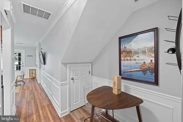 a view of a livingroom with furniture wooden floor and front door