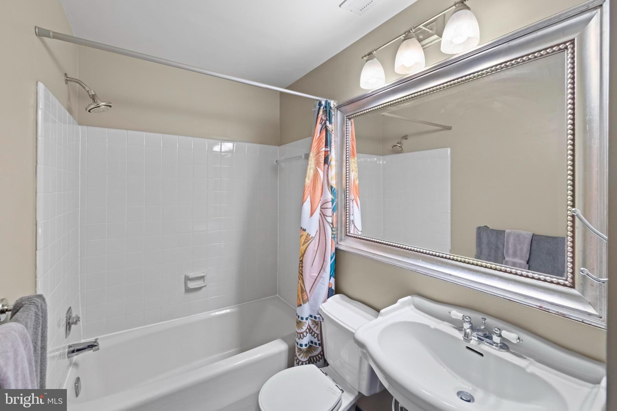 4613 MacArthur Boulevard Northwest, Unit A Washington, DC 20007 - Photo 13 of 21 a bathroom with a sink toilet and shower