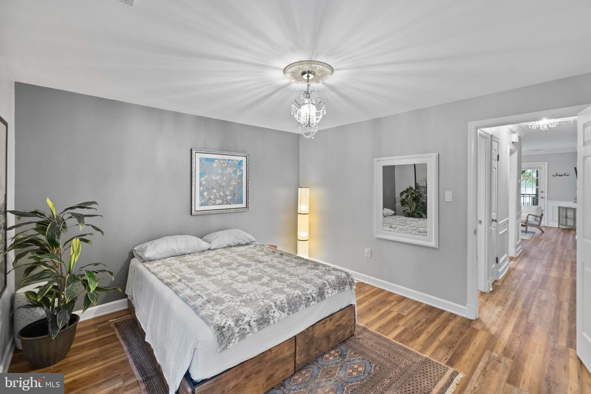 4613 MacArthur Boulevard Northwest, Unit A Washington, DC 20007 - Photo 16 of 21 a bedroom with a bed chandelier and a window