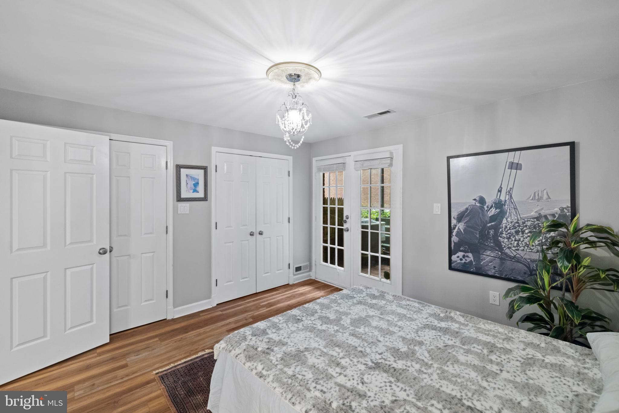 4613 MacArthur Boulevard Northwest, Unit A Washington, DC 20007 - Photo 17 of 21 a bedroom with a large bed and a chandelier
