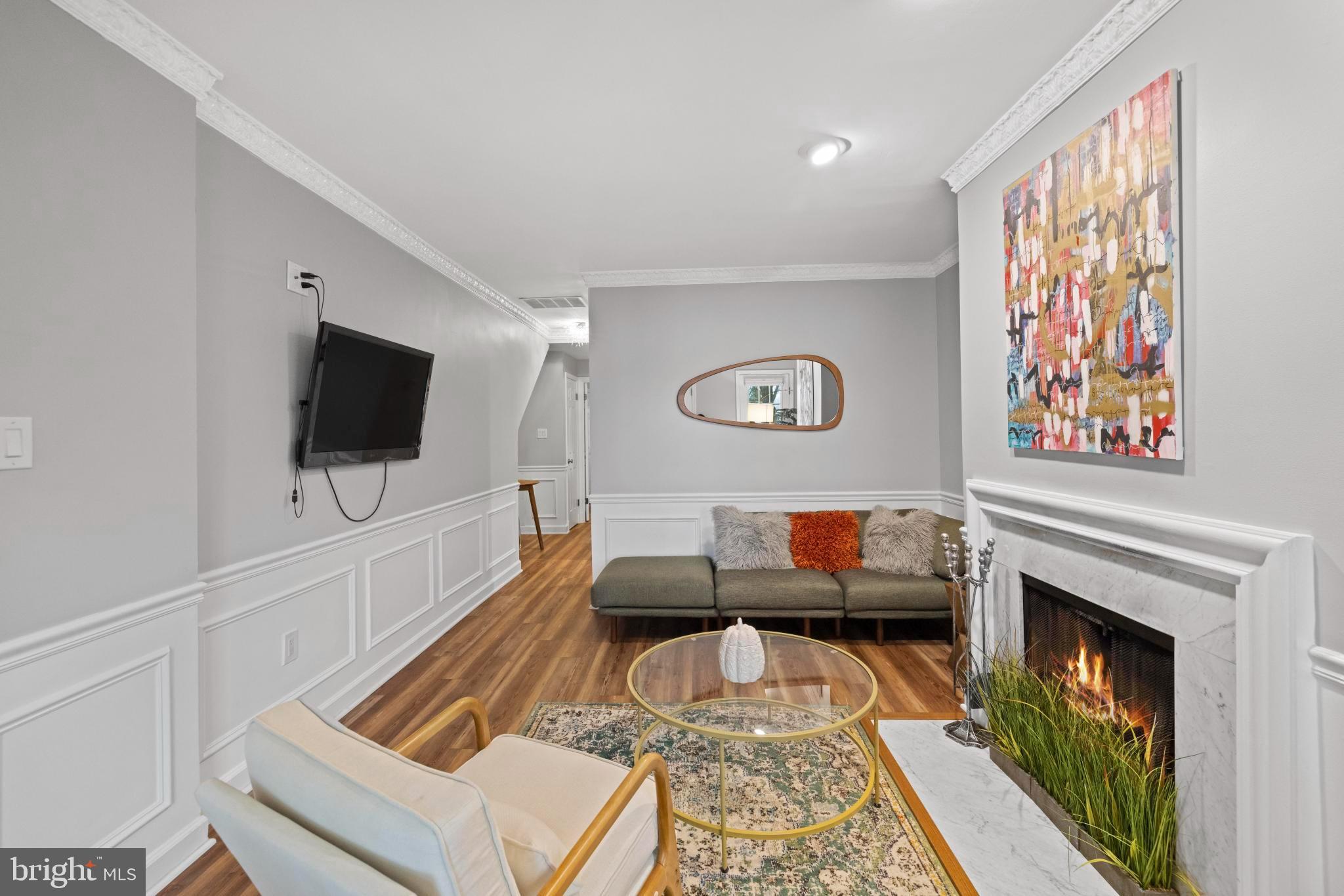 4613 MacArthur Boulevard Northwest, Unit A Washington, DC 20007 - Photo 6 of 21 a living room with furniture and a flat screen tv