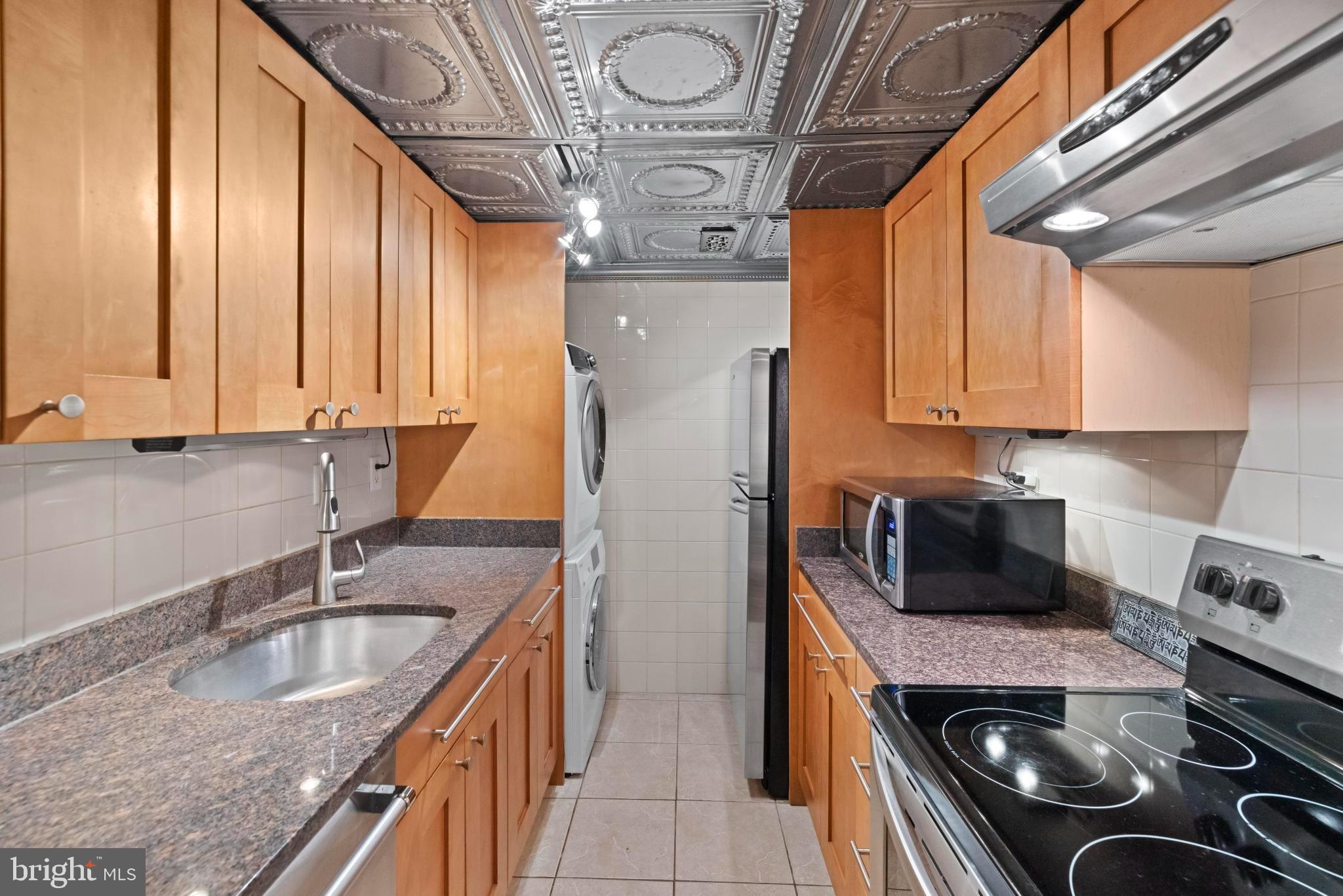 4613 MacArthur Boulevard Northwest, Unit A Washington, DC 20007 - Photo 7 of 21 a kitchen with a sink stove and cabinets