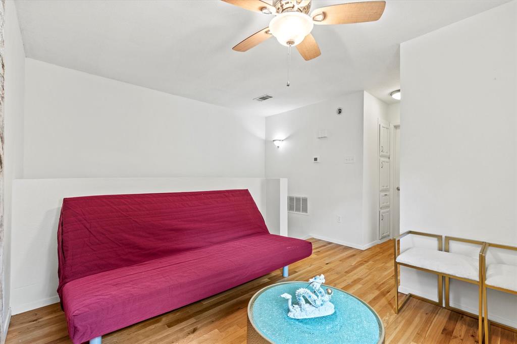 5626 Preston Oaks Road, Unit 51D Dallas, TX 75254 - Photo 13 of 19 a living room with furniture and wooden floor