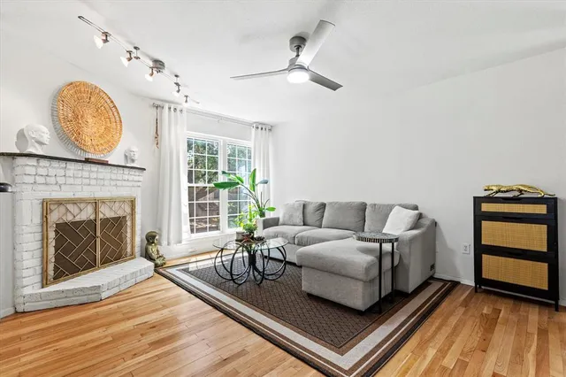 a living room with furniture a large window and a fireplace
