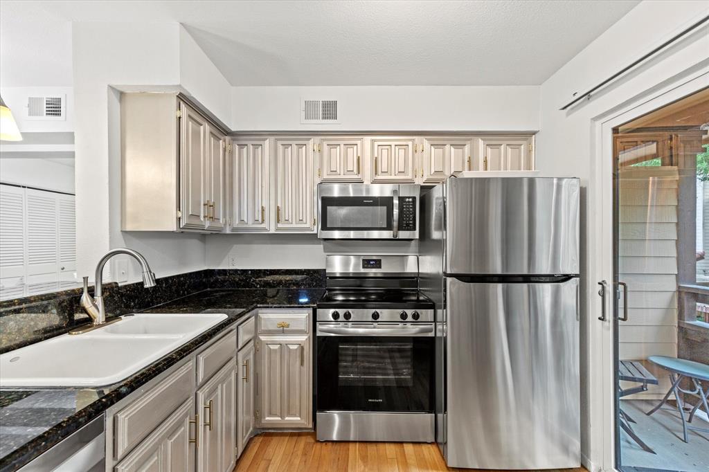 5626 Preston Oaks Road, Unit 51D Dallas, TX 75254 - Photo 7 of 19 a kitchen with a refrigerator stove and sink