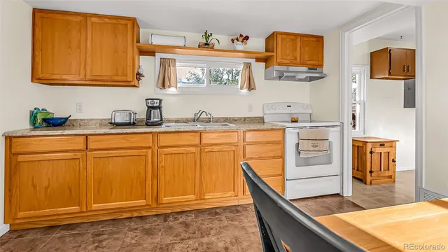 a kitchen with stainless steel appliances granite countertop a sink stove and cabinets