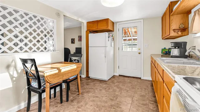a kitchen that has a table and chairs in it