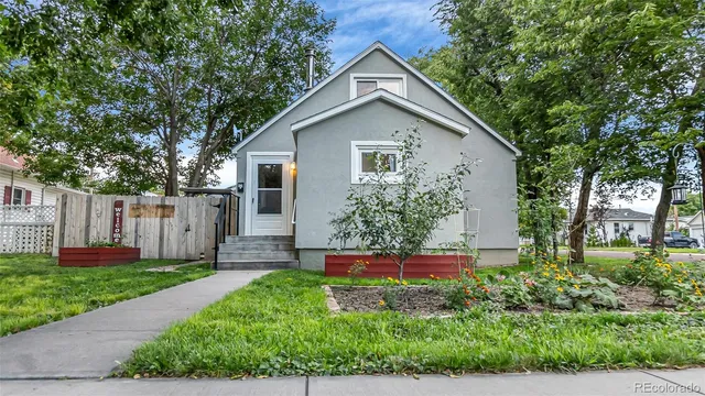 a view of house with backyard space and garden