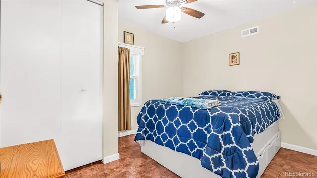 a bedroom with a bed and painting on the wall