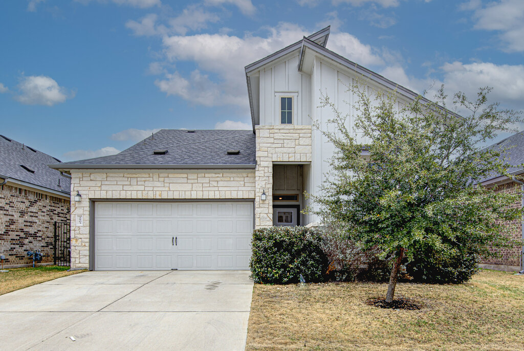 a front view of a house with garage
