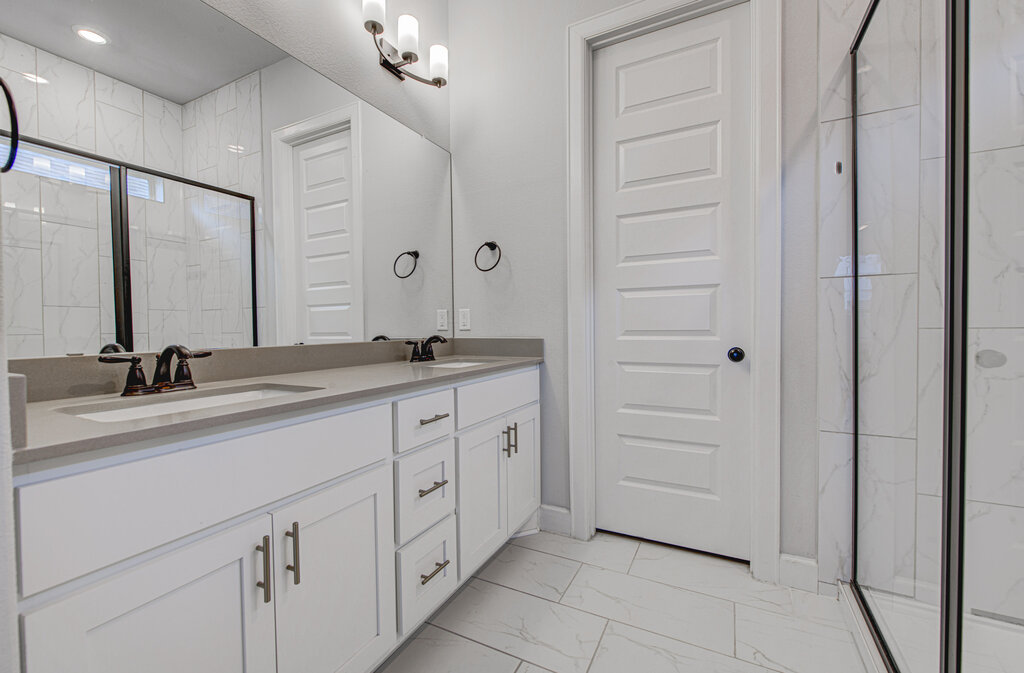 2903 Sebring Circle Austin, TX 78747 - Photo 12 of 31 a bathroom with a double vanity sink and a mirror