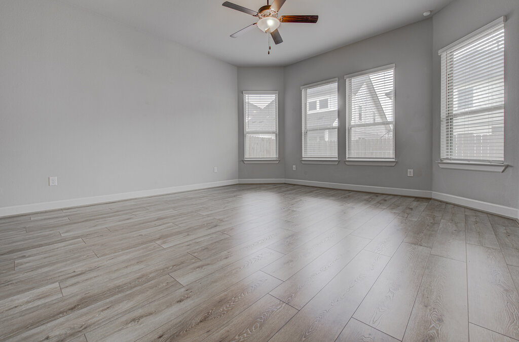 2903 Sebring Circle Austin, TX 78747 - Photo 14 of 31 wooden floor in an empty room with a window