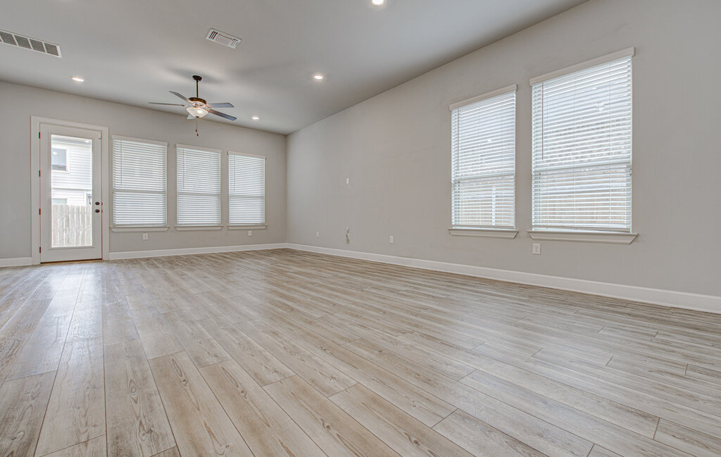 2903 Sebring Circle Austin, TX 78747 - Photo 16 of 31 an empty room with wooden floor and windows