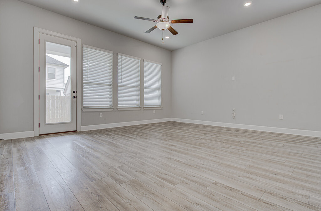 2903 Sebring Circle Austin, TX 78747 - Photo 18 of 31 an empty room with wooden floor ceiling fan and windows