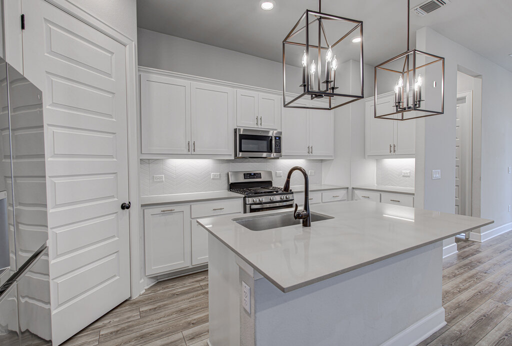 2903 Sebring Circle Austin, TX 78747 - Photo 19 of 31 a kitchen with granite countertop a sink cabinets and stainless steel appliances