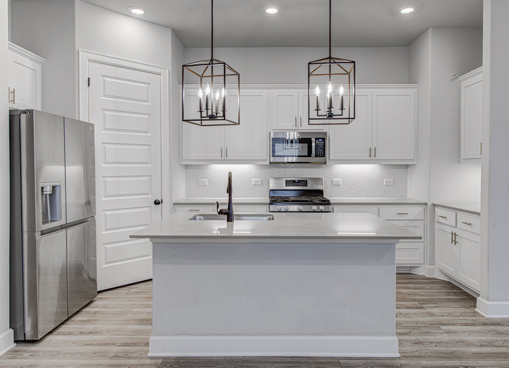 2903 Sebring Circle Austin, TX 78747 - Photo 20 of 31 a kitchen with stainless steel appliances granite countertop a sink a stove and refrigerator