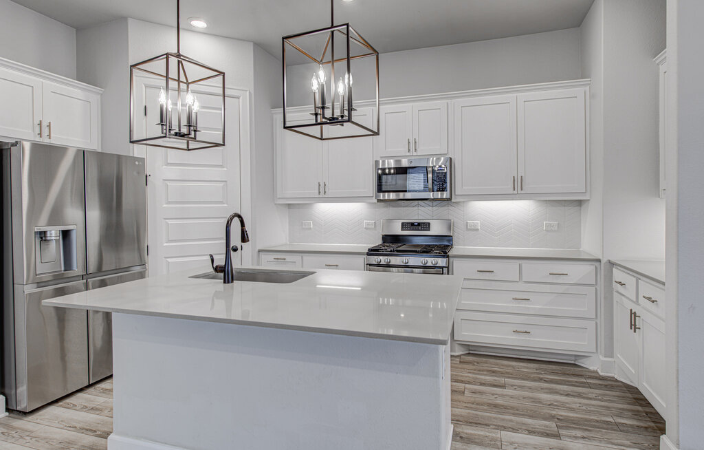 2903 Sebring Circle Austin, TX 78747 - Photo 22 of 31 a kitchen with stainless steel appliances granite countertop a refrigerator and stove
