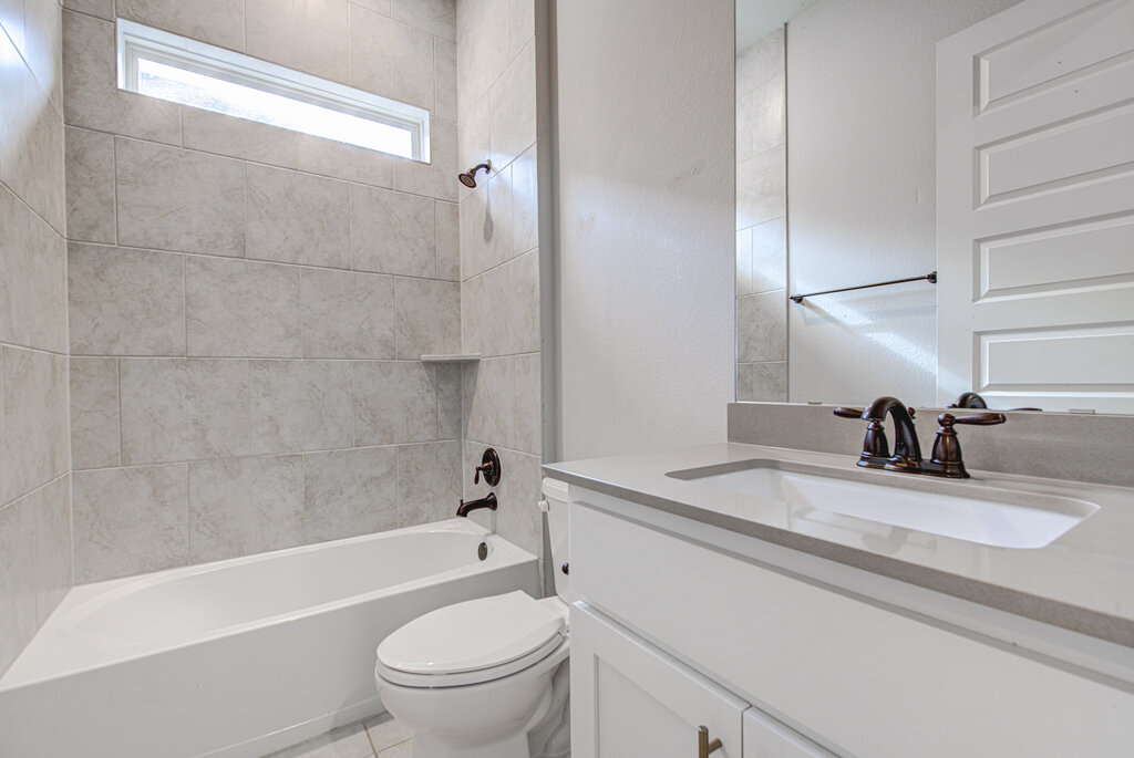2903 Sebring Circle Austin, TX 78747 - Photo 6 of 31 a bathroom with a granite countertop sink toilet and shower