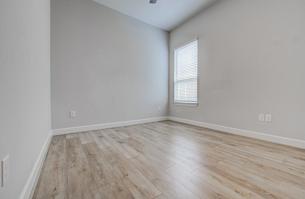 2903 Sebring Circle Austin, TX 78747 - Photo 7 of 31 an empty room with wooden floor and windows