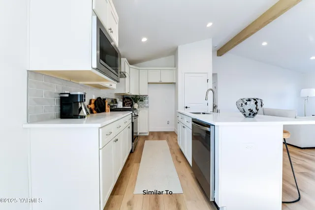a kitchen with a white stove top oven and white refrigerator