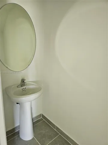 a bathroom with a sink and mirror