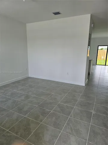 a view of an empty room with windows