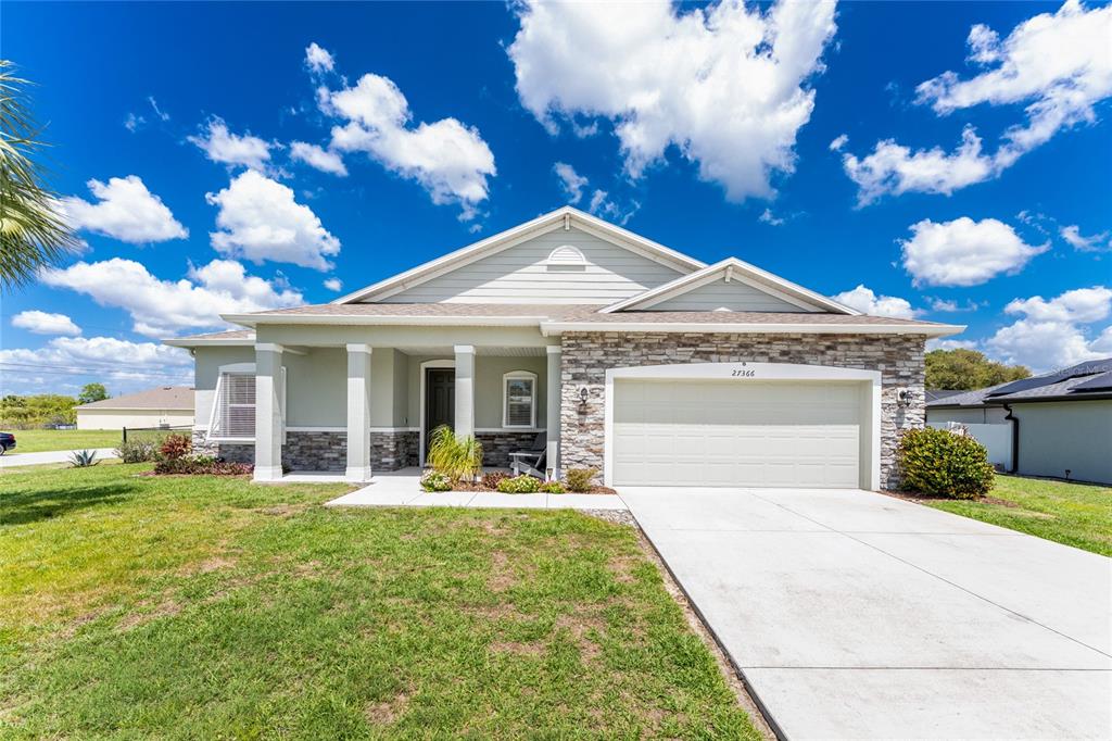 27366 Deep Creek Boulevard Punta Gorda, FL 33983 - Photo 1 of 63 a front view of a house with a yard and potted plants