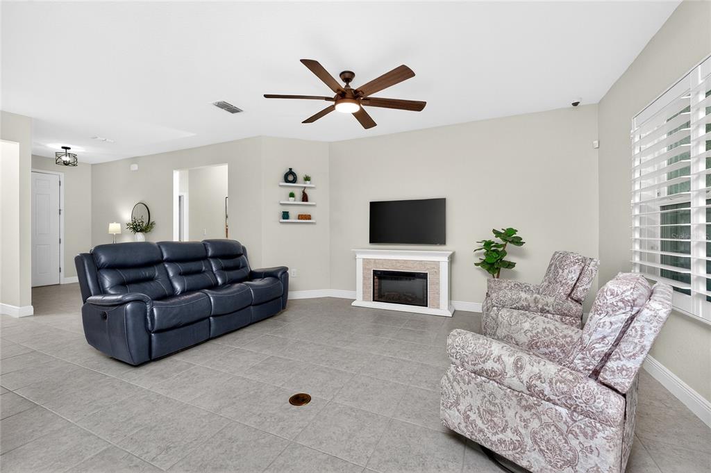 27366 Deep Creek Boulevard Punta Gorda, FL 33983 - Photo 15 of 63 a living room with furniture a fireplace and a window