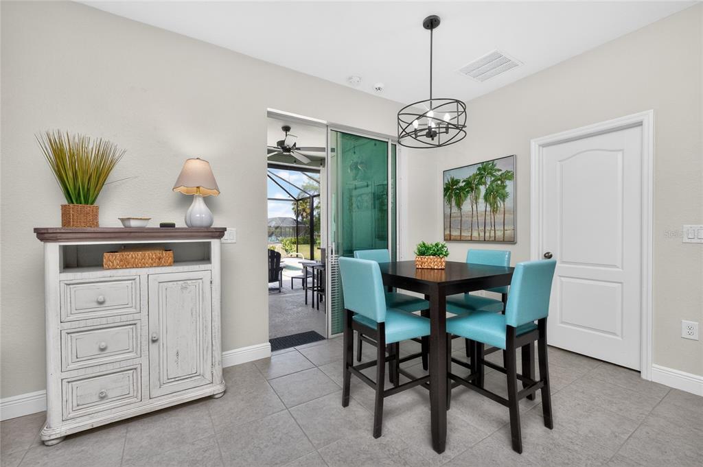 27366 Deep Creek Boulevard Punta Gorda, FL 33983 - Photo 16 of 63 a view of a dining room with furniture and chandelier