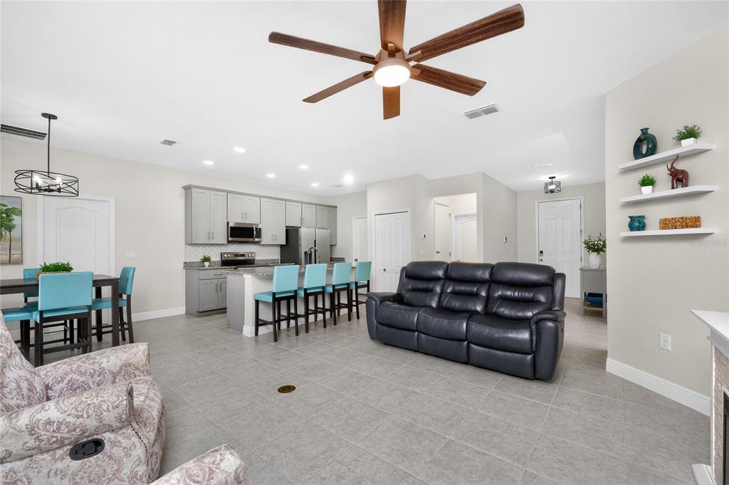 27366 Deep Creek Boulevard Punta Gorda, FL 33983 - Photo 19 of 63 a living room with furniture kitchen view and a chandelier