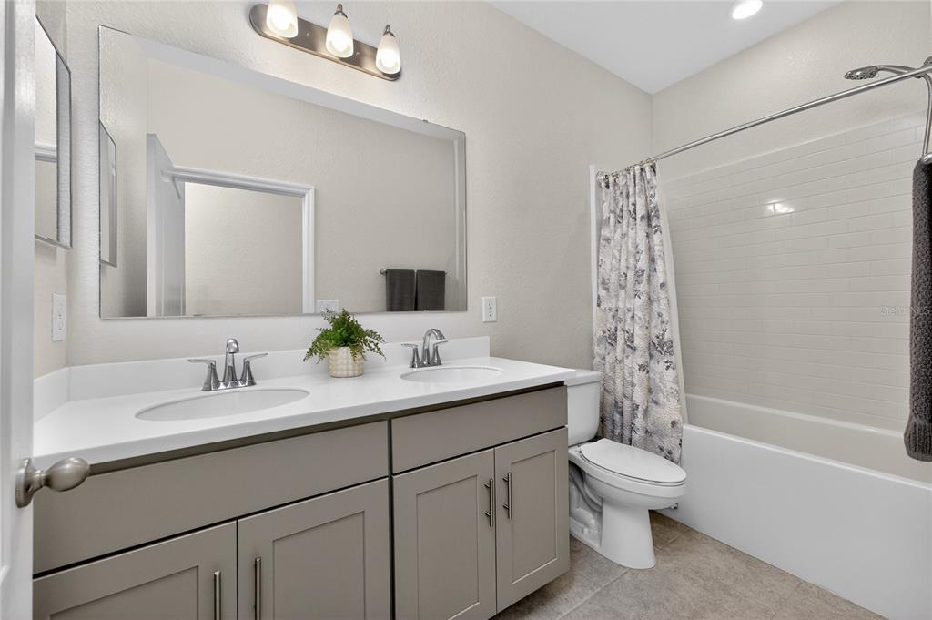 27366 Deep Creek Boulevard Punta Gorda, FL 33983 - Photo 25 of 63 a bathroom with a granite countertop sink a toilet and a bathtub