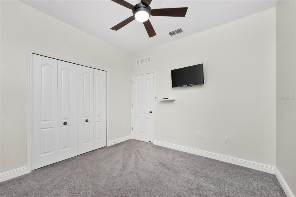 27366 Deep Creek Boulevard Punta Gorda, FL 33983 - Photo 31 of 63 an empty room with a ceiling fan and a window