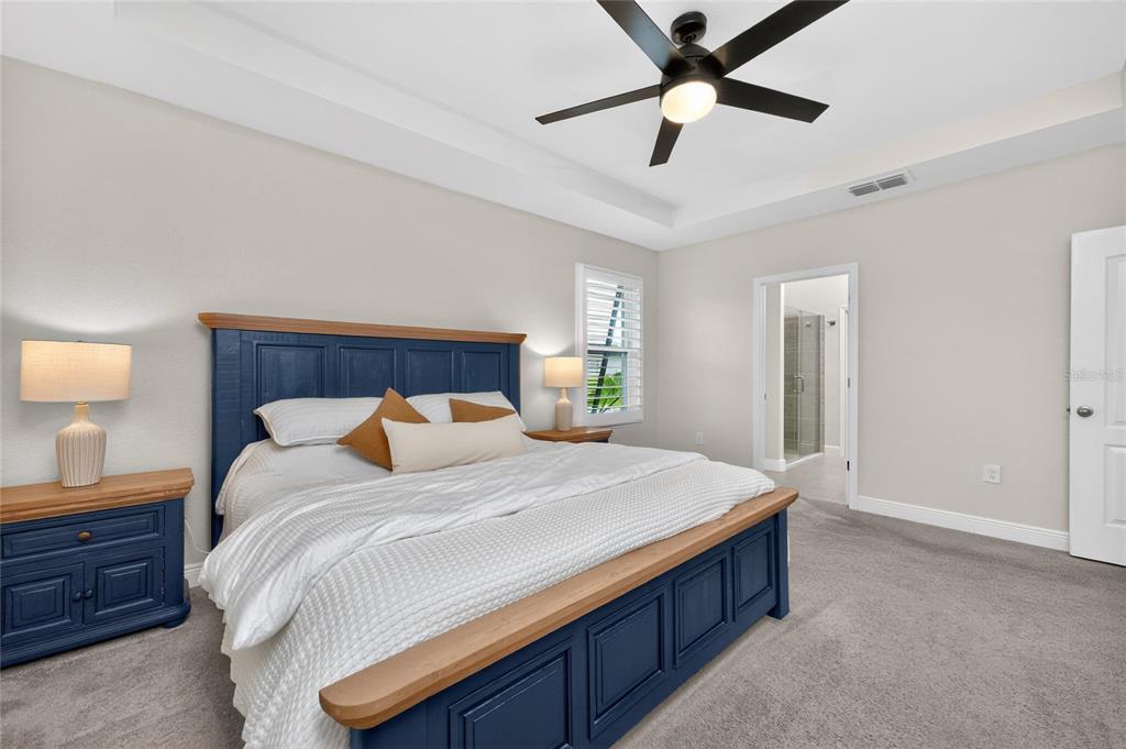 27366 Deep Creek Boulevard Punta Gorda, FL 33983 - Photo 34 of 63 a bedroom with a bed and a chandelier