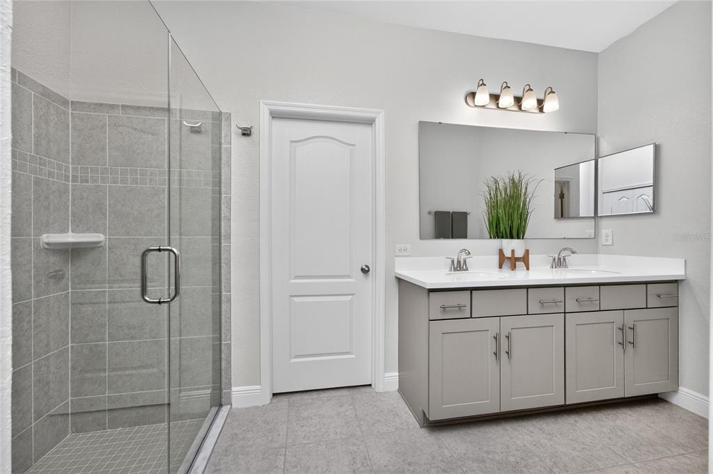 27366 Deep Creek Boulevard Punta Gorda, FL 33983 - Photo 35 of 63 a bathroom with a double vanity sink mirror and shower