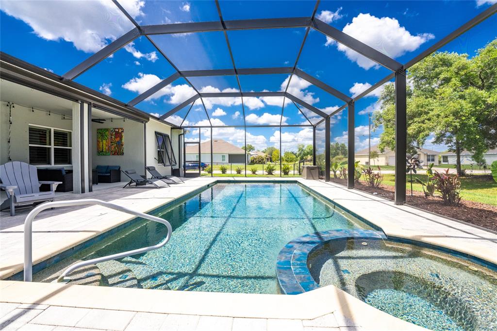 27366 Deep Creek Boulevard Punta Gorda, FL 33983 - Photo 48 of 63 a swimming pool with outdoor seating and yard