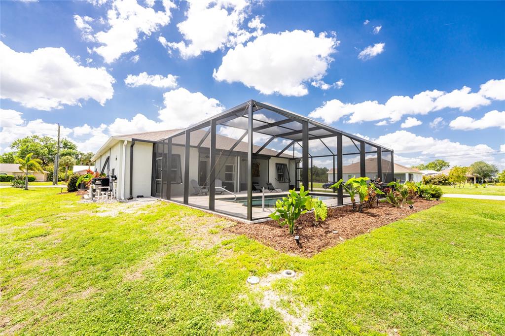 27366 Deep Creek Boulevard Punta Gorda, FL 33983 - Photo 50 of 63 a backyard of a house with table and chairs