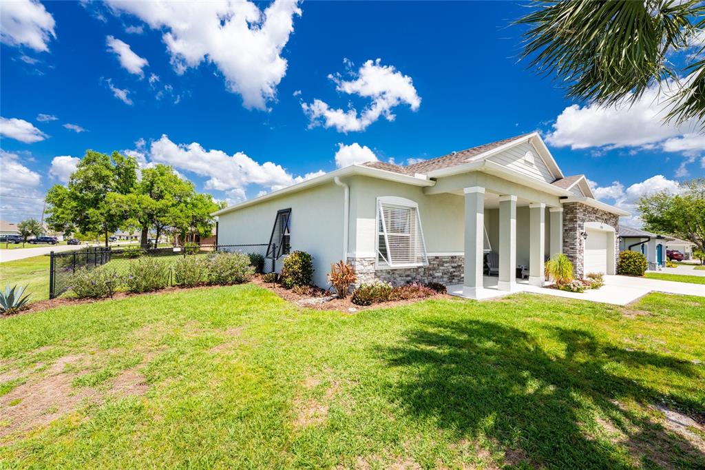 27366 Deep Creek Boulevard Punta Gorda, FL 33983 - Photo 62 of 63 a view of a house with a big yard and potted plants
