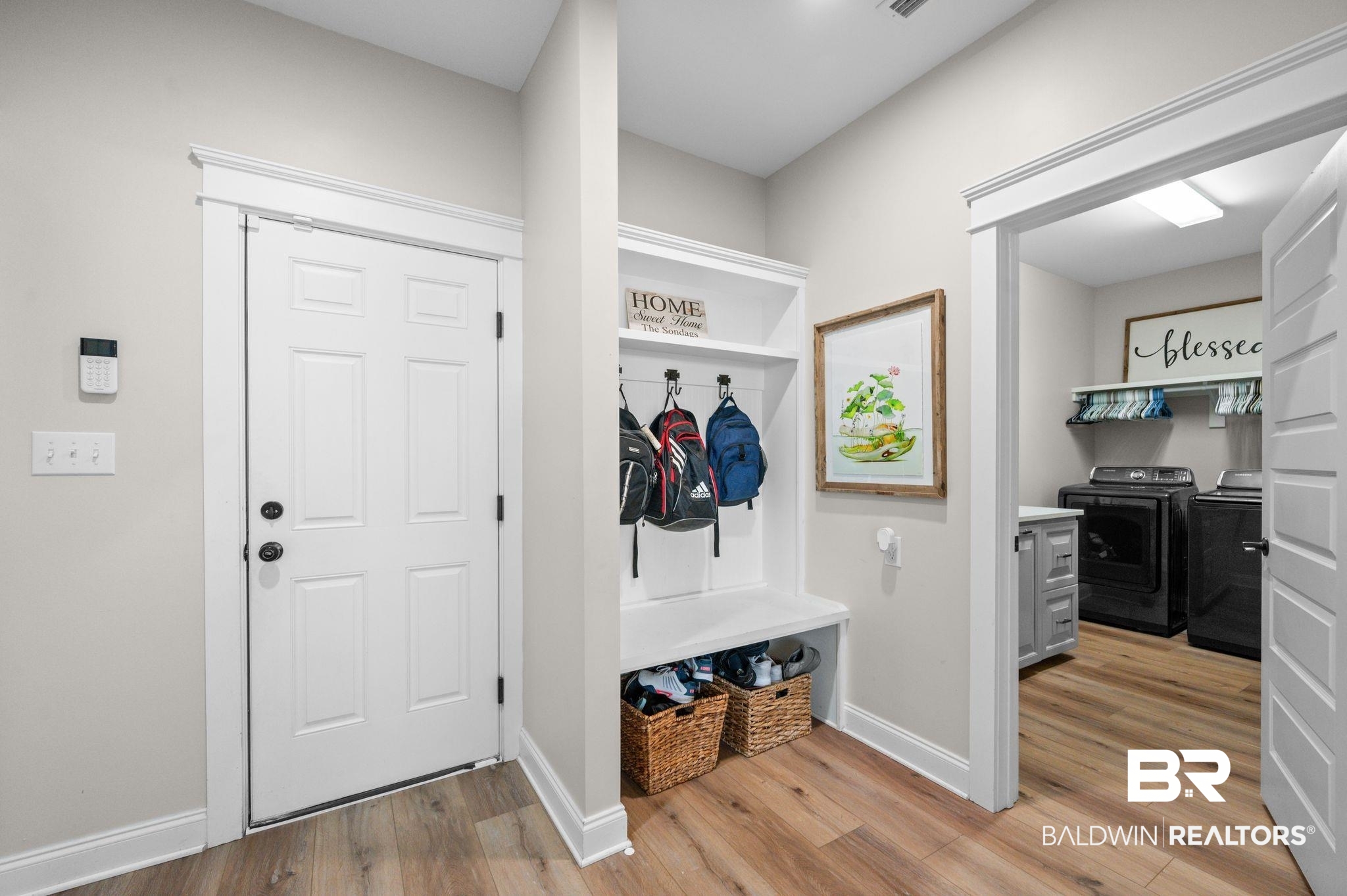 409 Fortune Drive Fairhope, AL 36532 - Photo 32 of 42 Entryway featuring wood-finish flooring, a built-in hall tree with storage bench, and white paneled doors