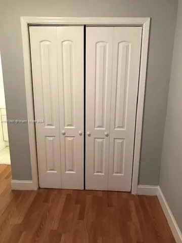 a view of a room with wooden floor